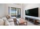 Bright living room with a comfortable sofa, a coffee table, and a sliding glass door to the outside balcony at 2511 W Queen Creek Rd # 479, Chandler, AZ 85248