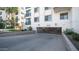 Exterior showing a parking area with security gate, surrounded by greenery and building exterior at 2511 W Queen Creek Rd # 479, Chandler, AZ 85248