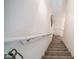 Carpeted staircase with white walls and handrail, offering a modern look and safe passage between floors at 2511 W Queen Creek Rd # 479, Chandler, AZ 85248