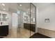 Luxurious bathroom with glass-enclosed shower, double vanities, and tile flooring, creating a spa-like retreat at 26535 W Mcrae Dr, Buckeye, AZ 85396