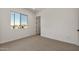 Cozy bedroom with a neutral carpet and a well-lit, minimalist aesthetic at 26535 W Mcrae Dr, Buckeye, AZ 85396