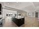 Spacious kitchen featuring a center island with a sink, dark cabinetry, and modern stainless steel appliances at 26535 W Mcrae Dr, Buckeye, AZ 85396