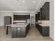 Modern kitchen featuring a large island, dark cabinets, stainless steel appliances, and quartz countertops at 26535 W Mcrae Dr, Buckeye, AZ 85396