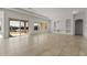 Expansive living room with tile floors, built-in shelves, and large sliding glass doors to the outdoors at 26535 W Mcrae Dr, Buckeye, AZ 85396