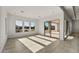 Bright living room featuring large windows and sliding glass doors leading to an outdoor space at 26535 W Mcrae Dr, Buckeye, AZ 85396