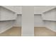 Spacious walk-in closet with ample shelving and carpeted floor, offering organized storage solutions at 26535 W Mcrae Dr, Buckeye, AZ 85396