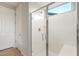 Modern bathroom features a glass shower with a built in seat, and a light filtering window at 26982 W Lone Cactus Dr, Buckeye, AZ 85396