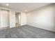 Spacious carpeted bedroom with neutral paint, access to bathroom, and natural light at 26982 W Lone Cactus Dr, Buckeye, AZ 85396