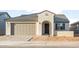 Charming single-story home with a two-car garage, arched entry, and tile roof at 26982 W Lone Cactus Dr, Buckeye, AZ 85396