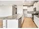 Bright kitchen with white cabinets, granite counters, stainless steel appliances, and a large island at 26982 W Lone Cactus Dr, Buckeye, AZ 85396