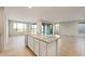 Open concept: Kitchen island with granite countertop offers space to cook and entertain at 26982 W Lone Cactus Dr, Buckeye, AZ 85396