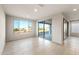 Bright living room featuring neutral paint, tile floors, and large windows with plenty of natural light at 26982 W Lone Cactus Dr, Buckeye, AZ 85396