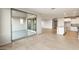 Open living space featuring tile floors, neutral paint, and access to the kitchen and backyard at 26982 W Lone Cactus Dr, Buckeye, AZ 85396