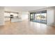 Open living space featuring tile floors, neutral paint, kitchen with island, and backyard access at 26982 W Lone Cactus Dr, Buckeye, AZ 85396