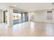 Open living space featuring tile floors, neutral paint, and large sliding glass doors to the patio at 26982 W Lone Cactus Dr, Buckeye, AZ 85396