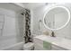 Bright bathroom featuring shower/tub, floral curtain, modern vanity and illuminated mirror at 3102 E Clarendon Ave # 210, Phoenix, AZ 85016