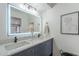 Modern bathroom featuring dual sinks, gray vanity, quartz countertop, and large, illuminated mirror at 3102 E Clarendon Ave # 210, Phoenix, AZ 85016