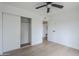 Bedroom featuring wood-look floors, closet with sliding doors, and neutral paint at 3102 E Clarendon Ave # 210, Phoenix, AZ 85016