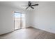 Bright bedroom featuring wood-look floors, ceiling fan, and a sliding glass door to a balcony at 3102 E Clarendon Ave # 210, Phoenix, AZ 85016