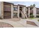 Multi-level condo featuring a courtyard entrance, earthy-toned stucco, and a unique architectural design, perfect for stylish living at 3102 E Clarendon Ave # 210, Phoenix, AZ 85016