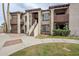 Inviting condo exterior with well-maintained landscaping, stucco, and private balcony at 3102 E Clarendon Ave # 210, Phoenix, AZ 85016