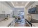Kitchen with updated appliances, quartz countertops, and an open view to the dining area and balcony at 3102 E Clarendon Ave # 210, Phoenix, AZ 85016