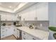 Modern kitchen with white cabinets, quartz countertops, gray tile backsplash, and stainless steel appliances at 3102 E Clarendon Ave # 210, Phoenix, AZ 85016