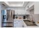 Bright kitchen with stainless steel refrigerator, white cabinetry, stainless steel sink, and quartz countertops at 3102 E Clarendon Ave # 210, Phoenix, AZ 85016