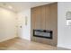 Modern living room featuring a wood panel fireplace, and neutral walls, creating a unique open and airy space at 3102 E Clarendon Ave # 210, Phoenix, AZ 85016