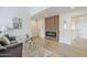 Contemporary living room featuring a wood panel fireplace, gray sofa with decor, and access to other rooms, an inviting space at 3102 E Clarendon Ave # 210, Phoenix, AZ 85016
