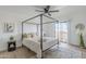 Light bedroom featuring a canopy bed, ceiling fan, wood-look floors, and sliding glass door to patio at 3102 E Clarendon Ave # 210, Phoenix, AZ 85016
