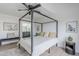 Bright bedroom with a canopy bed, wood-look floors, decorative pillows, and doorway to ensuite bathroom at 3102 E Clarendon Ave # 210, Phoenix, AZ 85016