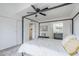 Spacious bedroom with a canopy bed, sliding closet doors, wood-look floors, and doorway to ensuite bathroom at 3102 E Clarendon Ave # 210, Phoenix, AZ 85016