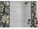 White shower with modern shower head and floral shower curtain at 3102 E Clarendon Ave # 210, Phoenix, AZ 85016