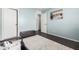 Well-lit bedroom with dark wood floors, neutral walls, and black bench, creating a versatile and inviting space at 335 S Travis --, Mesa, AZ 85208