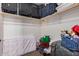 Walk-in closet with upper storage shelf for suitcases, bottom mattress, and organization bins at 335 S Travis --, Mesa, AZ 85208