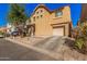 A two-story home shows desert landscaping, driveway to attached garage in a residential area at 335 S Travis --, Mesa, AZ 85208