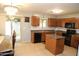 Traditional kitchen features wood cabinets, a tile backsplash, black appliances, access to the backyard at 335 S Travis --, Mesa, AZ 85208