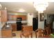 Traditional kitchen features wood cabinets, a tile backsplash, black appliances, and tile flooring at 335 S Travis --, Mesa, AZ 85208