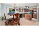 Kitchen with a dining area, tile floors, an island, brown cabinets and black appliances at 335 S Travis --, Mesa, AZ 85208