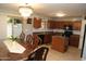 Traditional kitchen features wood cabinets, a tile backsplash, black appliances and an ornate chandelier at 335 S Travis --, Mesa, AZ 85208