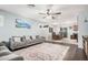 Open-concept living area flows into a dining space, featuring hardwood floors, a ceiling fan, and modern decor at 335 S Travis --, Mesa, AZ 85208