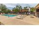 Community pool with lounge chairs for relaxing poolside in the sun at 335 S Travis --, Mesa, AZ 85208
