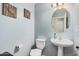 Cozy powder room featuring a pedestal sink, decorative wall art, and a light fixture that adds charm and functionality at 335 S Travis --, Mesa, AZ 85208