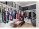 Well-organized walk-in closet with ample hanging space, shelving, and storage for suitcases for optimal storage solutions at 335 S Travis --, Mesa, AZ 85208