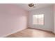 Bright bedroom with a view from the window, light wood floors, and white baseboards at 3440 W Mesquite St, Phoenix, AZ 85086