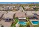 An aerial view of a home with a private backyard pool and covered patio nestled in a desert neighborhood at 346 E Red Mesa Trl, San Tan Valley, AZ 85143