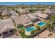 An aerial view of a home with a private backyard pool and view of the neighborhood and desert mountains at 346 E Red Mesa Trl, San Tan Valley, AZ 85143