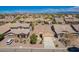 Expansive aerial view of a beige home with a tile roof in a well-planned community with mountain views at 346 E Red Mesa Trl, San Tan Valley, AZ 85143