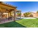 Enjoy outdoor living with a covered patio overlooking a pristine pool and artificial turf at 346 E Red Mesa Trl, San Tan Valley, AZ 85143